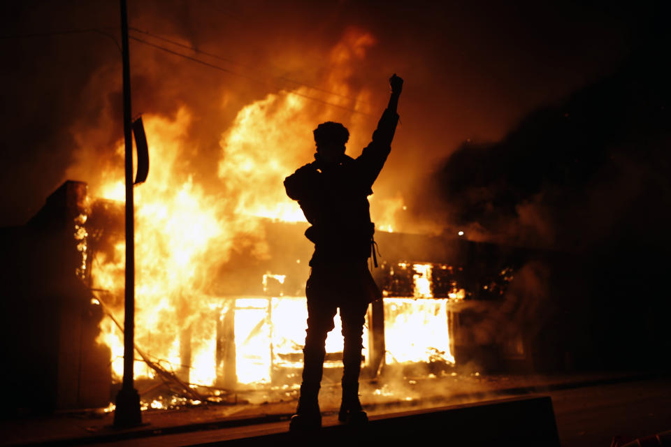 In this May 29, 2020, photo, a check-cashing business burns during protests in Minneapolis. Protests continued following the death of George Floyd, who died after being restrained by Minneapolis police officers on Memorial Day. (AP Photo/John Minchillo)