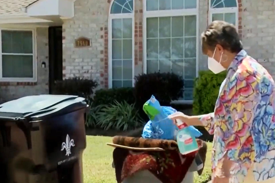 Image: New Orleans East homeowner Embra Bridges sprays bleach over her pile of trash, which she claims has not been touched since Ida hit. (WDSU)