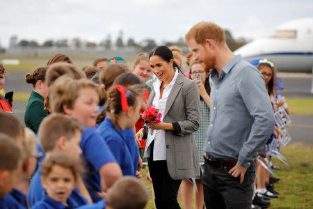 Britain's Prince Harry and Meghan, Duchess of Sussex, interact with children from Dubbo South Public School after arriving at Dubbo airport, Dubbo, Australia October 17, 2018. REUTERS/Phil Noble