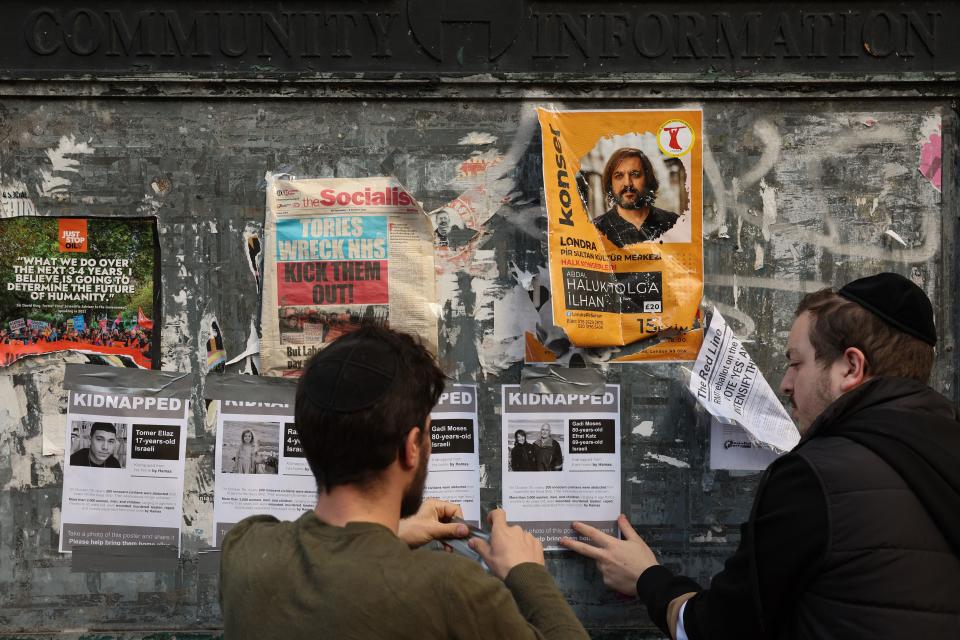 A group of young Jewish men put up posters showing recently kidnapped or missing Israelis after the Hamas attack in Israel, in Stamford Hill, north London on October 13, 2023. The UK government announced Thursday £3 million ($3.7 million) of extra funding to help protect the Jewish community from anti-Semitic attacks, after a reported 400 percent spike in incidents since Hamas's weekend attacks in Israel. (Photo by Daniel LEAL / AFP) (Photo by DANIEL LEAL/AFP via Getty Images)