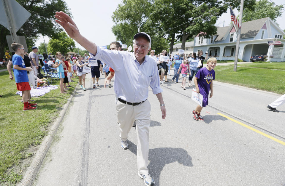 Sen. Bernie Sanders greets local residents while walking in a Fourth of July parade on Saturday, July 4, 2015 in Waukee, Iowa.