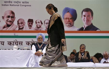 Sonia Gandhi, Chief of India's ruling Congress party, walks past India's Prime Minister Manmohan Singh (wearing turban) to address her party workers at the All India Congress Committee (AICC) meeting in New Delhi January 17, 2014. REUTERS/Adnan Abidi