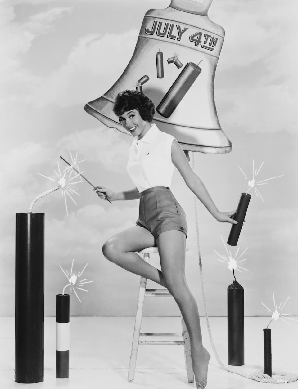 Maggie Pierce posing with July 4 firecrackers, 1960s vintage 4th of July