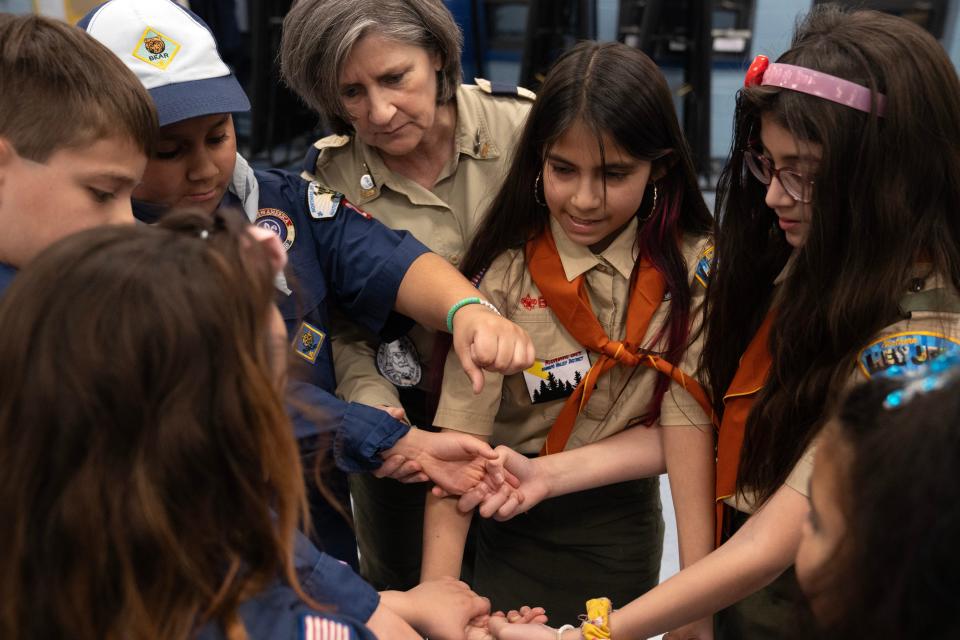 Mar 20, 2024; Prospect Park, NJ, USA; (From right) Isabella Rivera, Sophia Rodríguez, Cub Master Lisa Esteves, and Yanko Rivera as Prospect Park Cub Scout Pack 2 plays the human knot game during a meeting at Prospect Park Elementary School.