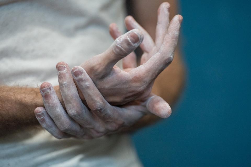 Cooper Myers rubs chalk on his hands as he climbs at Austin Bouldering Project on Monday, March 25, 2024. Myers used ChatGPT to figure out he didn't have the type 1 diabetes he had been diagnosed with. Instead he had a rare, genetic form called maturity-onset diabetes of the young or MODY. He's now able to eat what he wants and be active because of better blood sugar regulation.