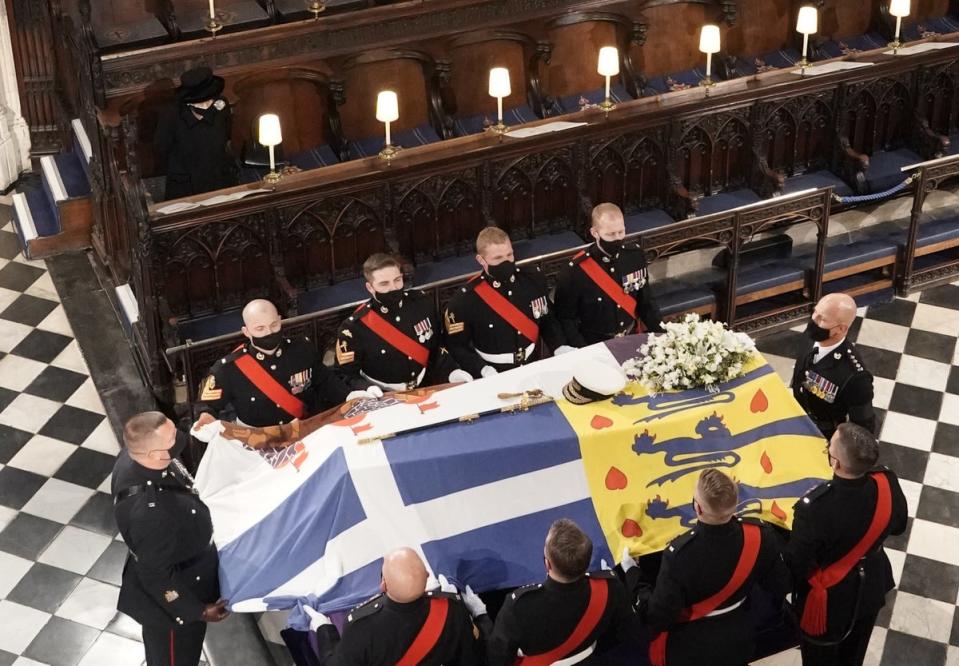 The Queen watches as the Duke of Edinburgh’s coffin is placed in St George’s Chapel (Jonathan Brady/PA) (PA Wire)