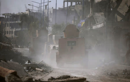Military vehicles are seen in Raqqa. REUTERS/Rodi Said