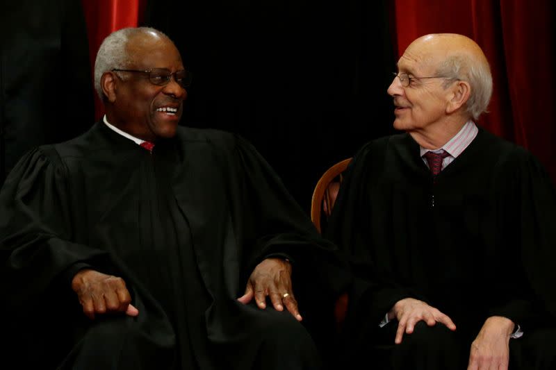 FILE PHOTO: Thomas and Breyer chat during a new U.S. Supreme Court family photo at the Supreme Court building in Washington