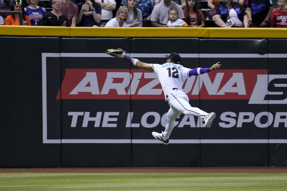 Arizona Diamondbacks left fielder Lourdes Gurriel Jr. makes a leaping catch on a line drive hit by Houston Astros' Jose Altuve during the first inning of a baseball game, Saturday, Sept. 30, 2023, in Phoenix. (AP Photo/Ross D. Franklin)