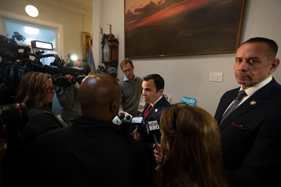 Sep 26, 2023; Paterson, NJ, USA; (Center) NJ Attorney General Matthew Platkin speaks with members of the press during an event at which (right) Paterson PD officer in charge Isa Abbassi unveiled his strategic plan for city law enforcement at the Paterson Public Library. Mandatory Credit: Michael Karas-The Record