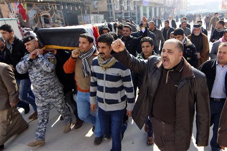 Mourners react during a funeral of an Iraqi soldier, who was killed during clashes in Ramadi, in Najaf, 160 km (99 miles) south of Baghdad, January 16, 2014. REUTERS/Ahmad Mousa