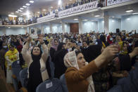 Delegates record the arrival of Afghan President Ashraf Ghani as they attend an Afghan Loya Jirga meeting in Kabul, Afghanistan, Friday, Aug. 7, 2020. The traditional council opened Friday in the Afghan capital to decide the release of a final 400 Taliban - the last hurdle to the start of negotiations between Kabul’s political leadership and the Taliban in keeping with a peace deal the United States signed with the insurgent movement in February. (AP Photo/Rahmat Gul)