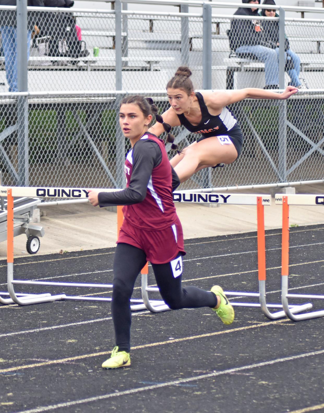 Union City's Nevada Gillons leads Quincy's Brookelyn Parker midway through the 100 meter hurdles. Gillons went on to win the race, Parker took second