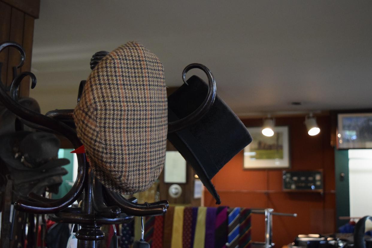 Fine hats on top of a hat rack during the sale for Hunter and Coggins, Sept. 19, 2023.