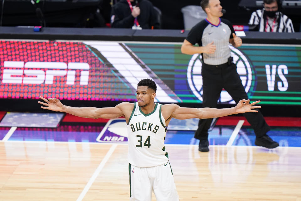 Milwaukee Bucks' Giannis Antetokounmpo reacts after making a three-pointer during overtime in an NBA basketball game against the Philadelphia 76ers, Wednesday, March 17, 2021, in Philadelphia. (AP Photo/Matt Slocum)