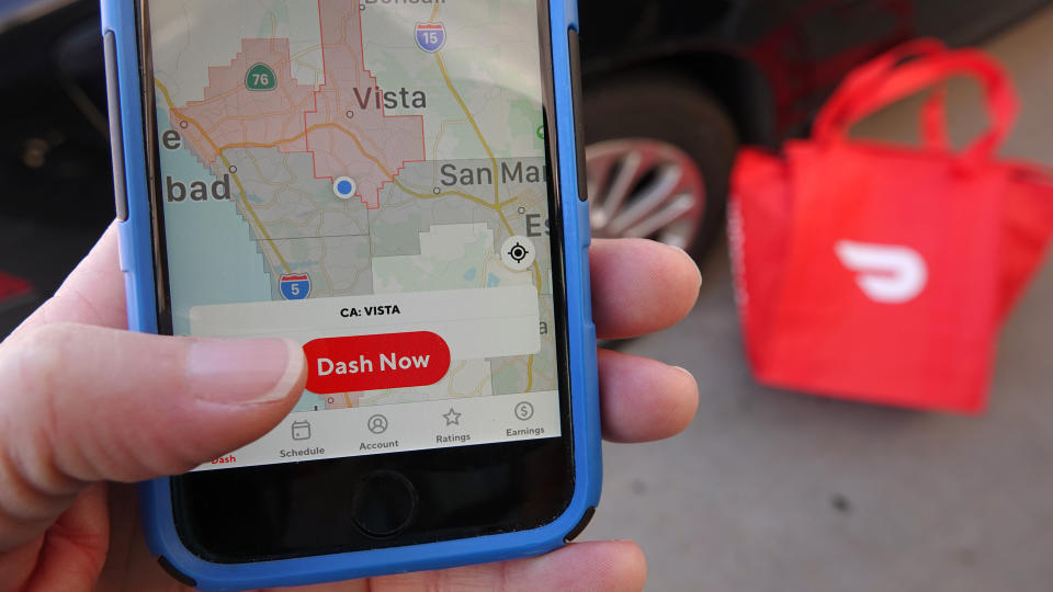 Close up of person logging into the DoorDash dasher app to begin delivering.