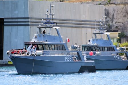 Patrol boats carrying migrants rescued by the Alan Kurdi vessel enter the Maltese harbour