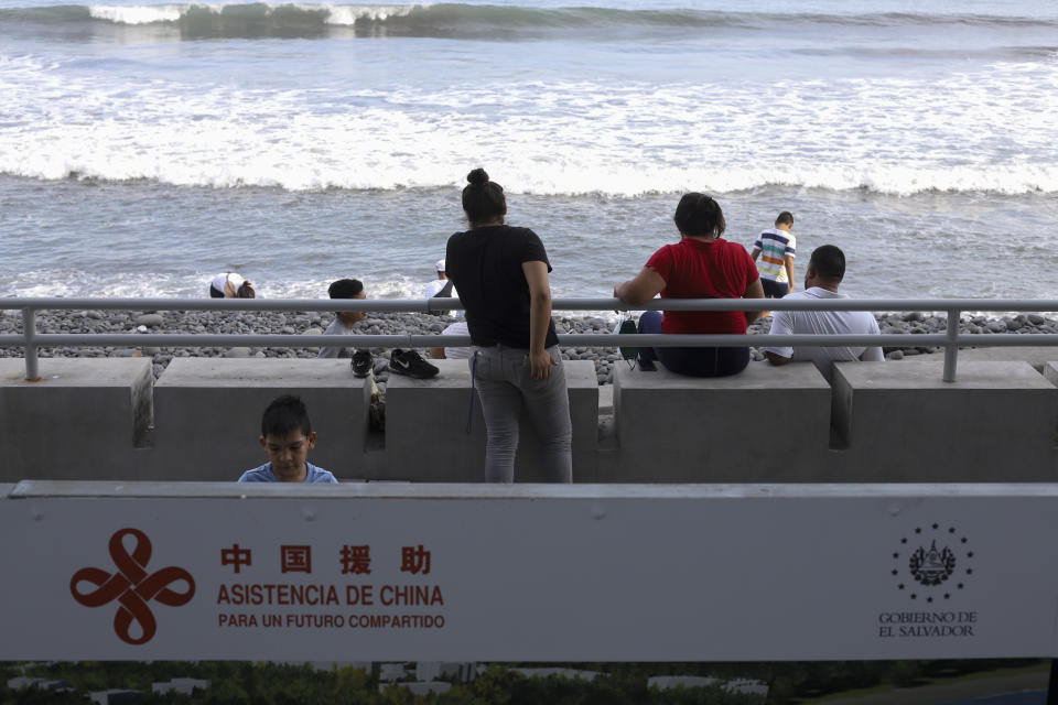 A sign with a message that reads in Spanish; "Assistance from China, for a shared future", is part of the remodeling work in the area of the boardwalk on the pier in La Libertad, El Salvador, Friday, June 18, 2021. Bukele is trying to improve El Salvador's relationship with China. But with a quarter of El Salvador's population living in the U.S. and sending home about $6 billion in remittances last year, no one believes China could begin to replace the deep ties to the United States. (AP Photo/Salvador Melendez)