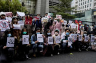 Supporters of Zhou Xiaoxuan hold banners as they wait for Zhou outside at a courthouse where she is appearing in a sexual harassment case in Beijing, Wednesday, Dec. 2, 2020. A high profile case of sexual harassment in China's #MeToo movement involving a well-known Chinese state TV host will be start on Wednesday in the capital city after pending for more than two years. Chinese characters read, "Lets's ask for an answer in history together." (AP Photo/Andy Wong)