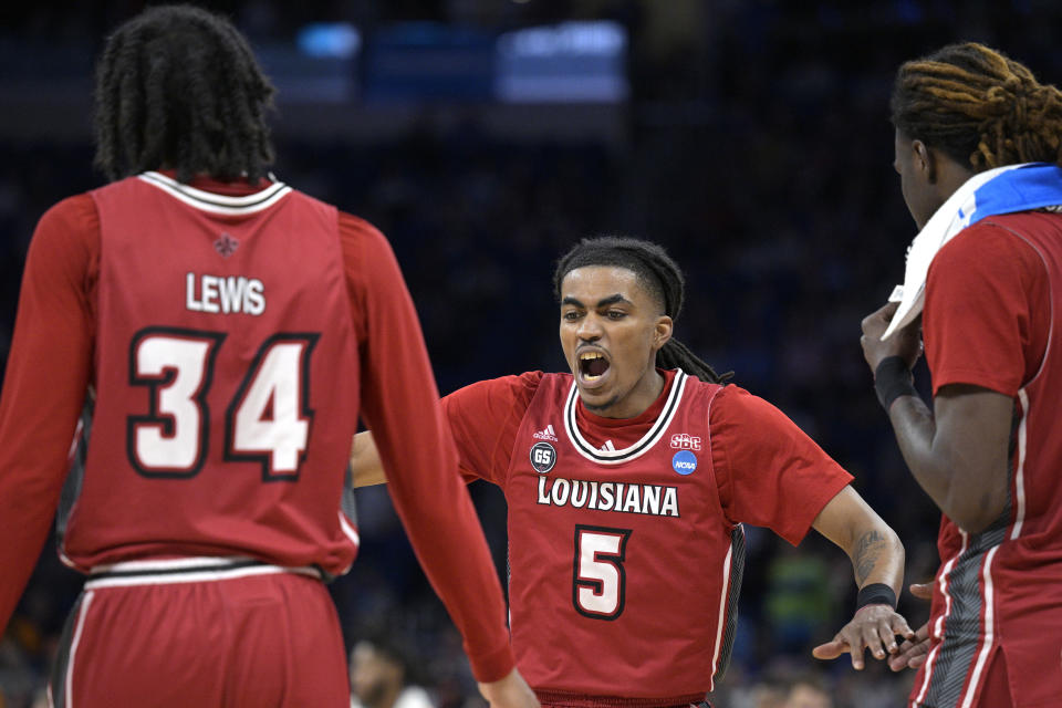 Louisiana guard Jalen Dalcourt (5) reacts with forwards Terence Lewis II (34) and Isaiah Richards (35) during the first half of a first-round college basketball game against Tennessee in the NCAA Tournament, Thursday, March 16, 2023, in Orlando, Fla. (AP Photo/Phelan M. Ebenhack)