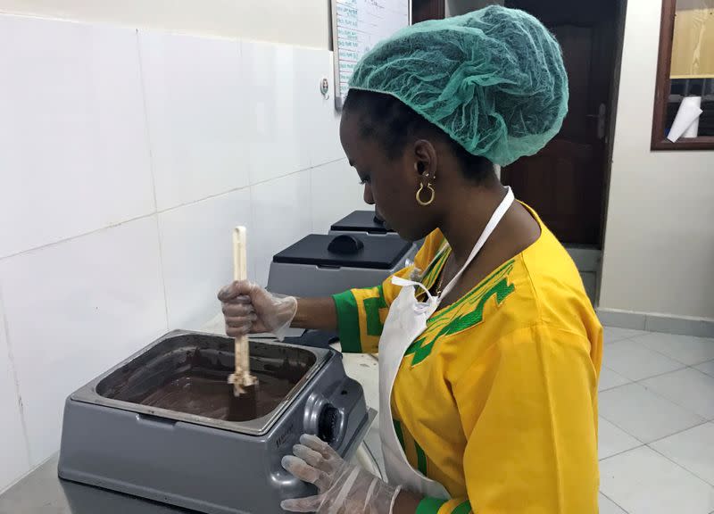 Chocolate maker Aisha Kalinda, 21, removes truffles from a chocolate mixture at the Lowa Chocolate Factory in Goma