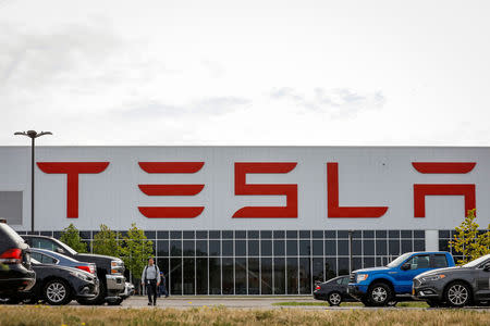 A worker is seen outside the Tesla Inc. Gigafactory 2, which is also known as RiverBend, a joint venture with Panasonic to produce solar panels and roof tiles in Buffalo, New York, U.S., August 2, 2018. REUTERS/Brendan McDermid/Files