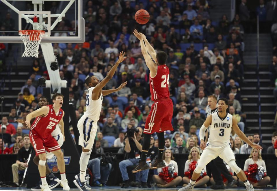 <p>Wisconsin guard Bronson Koenig (24) takes a three-point shot against Villanova guard Mikal Bridges (25) during the second half of a second-round men’s college basketball game in the NCAA Tournament, Saturday, March 18, 2017, in Buffalo, N.Y. Wisconsin won, 65-62. (AP Photo/Bill Wippert) </p>