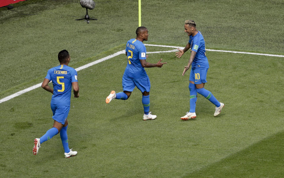 Neymar (right) celebrates with Douglas Costa (centre) after doubling Brazil’s lead