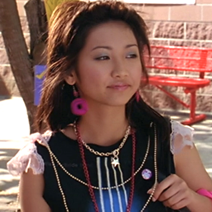 Brenda Song in colorful earrings and a lace and black top