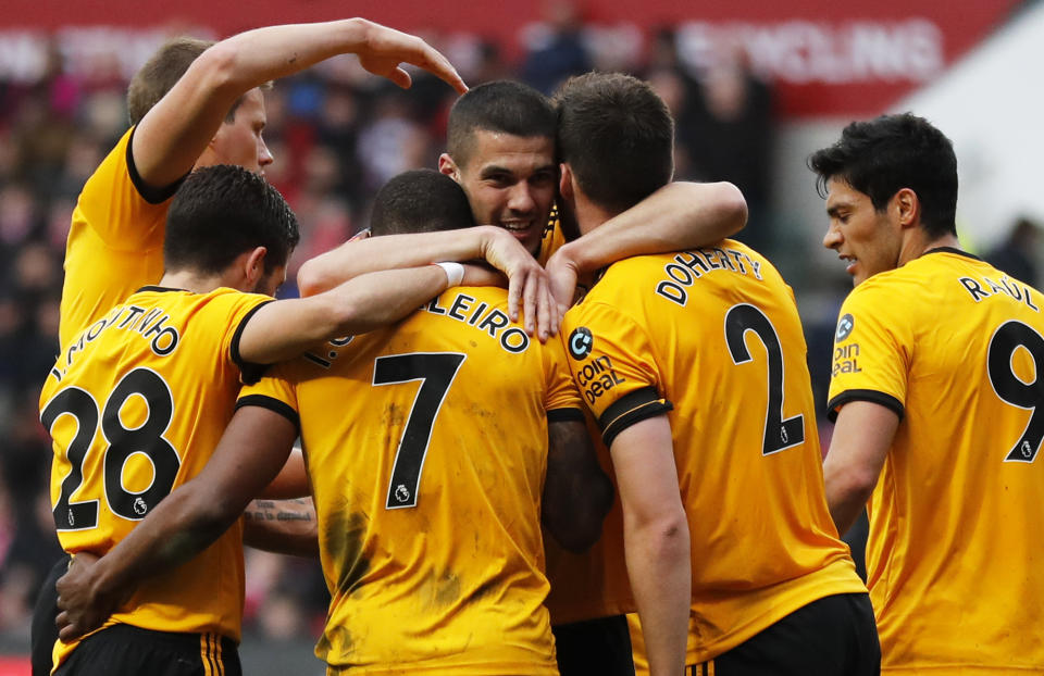 Wolverhampton players celebrate after Ivan Cavaleiro, center left, scored the opening goal during the English FA Cup fifth round soccer match between Bristol City and Wolverhampton Wanderers at Ashton Gate stadium in Bristol, England, Sunday, Feb. 17, 2019. (AP Photo/Frank Augstein)