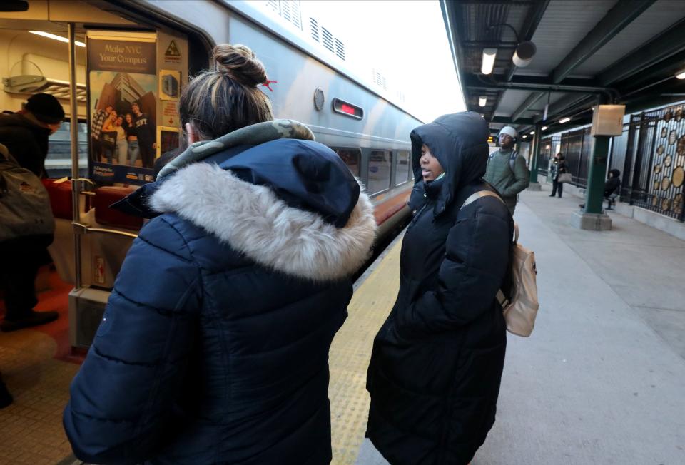 Bersy Garcia, right, boards a northbound Metro-North train at the Fordham Station in the Bronx, Feb. 8, 2024.