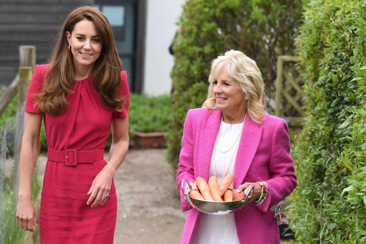 Britain's Catherine, Duchess of Cambridge talks with US First Lady Jill Biden as she carries carrots to feed a pet rabbit during their visit to Connor Downs Academy in Hayle, Cornwall on the sidelines of the G7 summit on June 11, 2021. (Photo by DANIEL LEAL-OLIVAS / various sources / AFP) (Photo by DANIEL LEAL-OLIVAS/AFP via Getty Images)