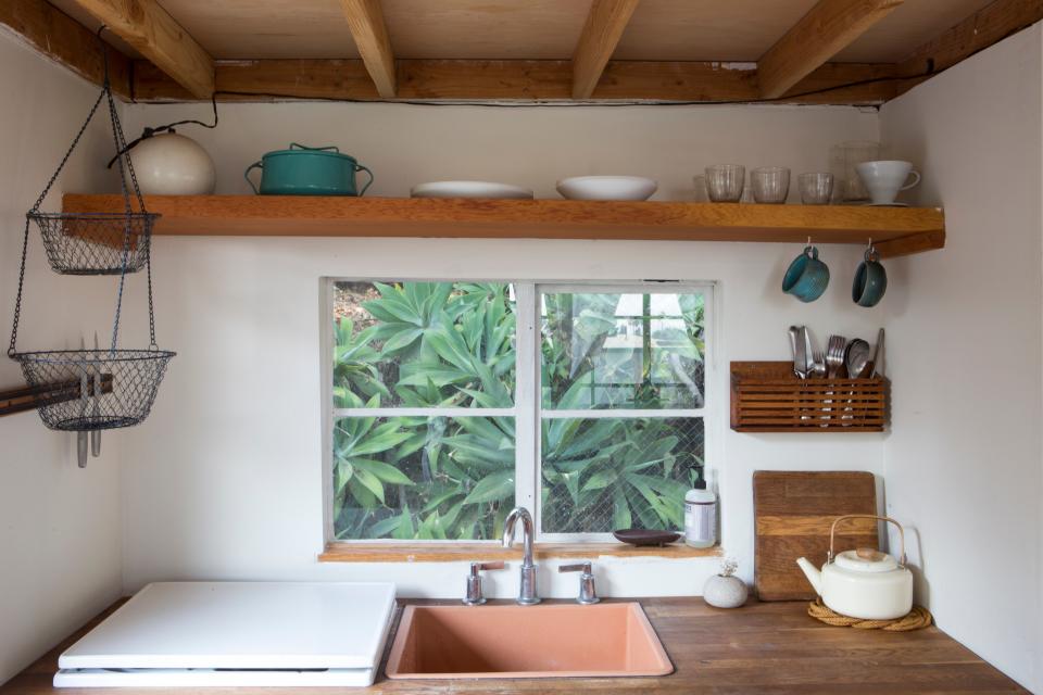 AFTER: The studio has a small kitchen that mimics the one upstairs and makes it so Grey or guests don’t need to go far for water or snacks.