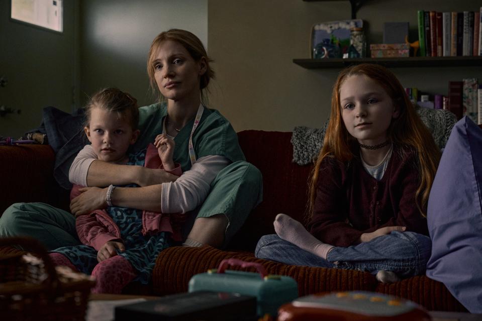 Amy (Jessica Chastain, center) with her daughters Maya (Devyn McDowell, left) and Alex (Alix West) in a scene from Netflix's "The Good Nurse."