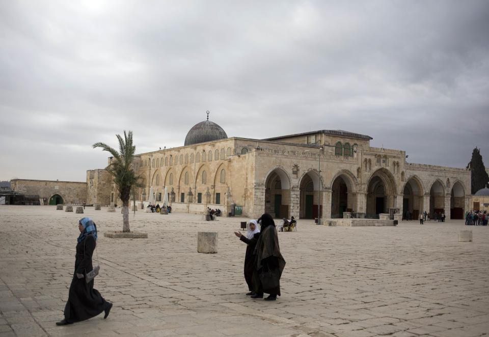 In this photo taken on Monday, Jan. 27, 2014, Palestinian women walk at the al-Aqsa mosque compound in Jerusalem. The mosque's library has a collection of some 4,000 old manuscripts with about a quarter considered in poor condition. Half of the books are already undergoing restoration funded by the Waqf, Jordan’s Islamic authority which manages the holy site, and with assistance from UNESCO. (AP Photo/Dusan Vranic)