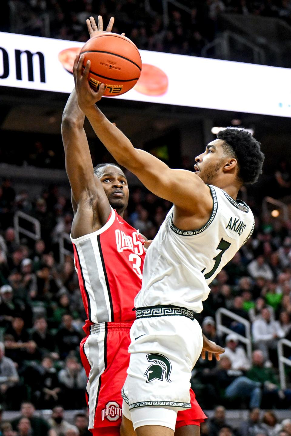 Michigan State's Jaden Akins, right, shoots as Ohio State's Felix Okpara defends during the first half on Sunday, Feb. 25, 2024, at the Breslin Center in East Lansing.