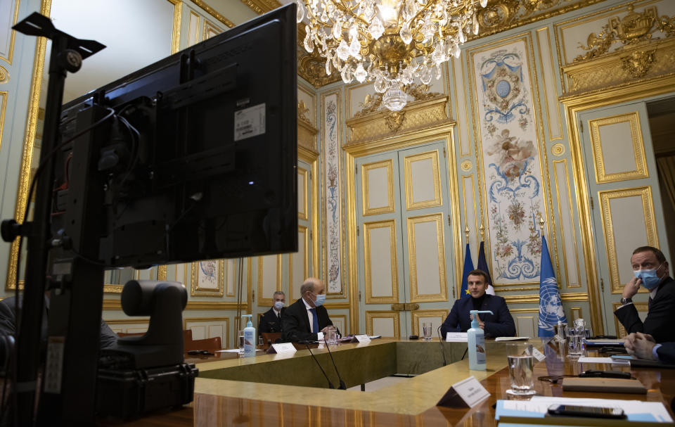 French President Emmanuel Macron, second from right, makes introductory remarks during a visio-conference meeting about support and aid for Lebanon, at the Elysee Palace in Paris, France, Wednesday, Dec. 2, 2020. France is hosting an international video conference on humanitarian aid for Lebanon amid political deadlock in Beirut that has blocked billions of dollars in assistance for the cash-strapped country. (Ian Langsdon, Pool via AP)