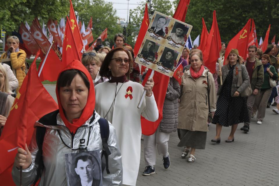 People walk with portraits of relatives who fought in World War II, during the Immortal Regiment action celebrating the 79th anniversary of the end of World War II, in Sevastopol, Crimea, Thursday, May 9, 2024. (AP Photo)