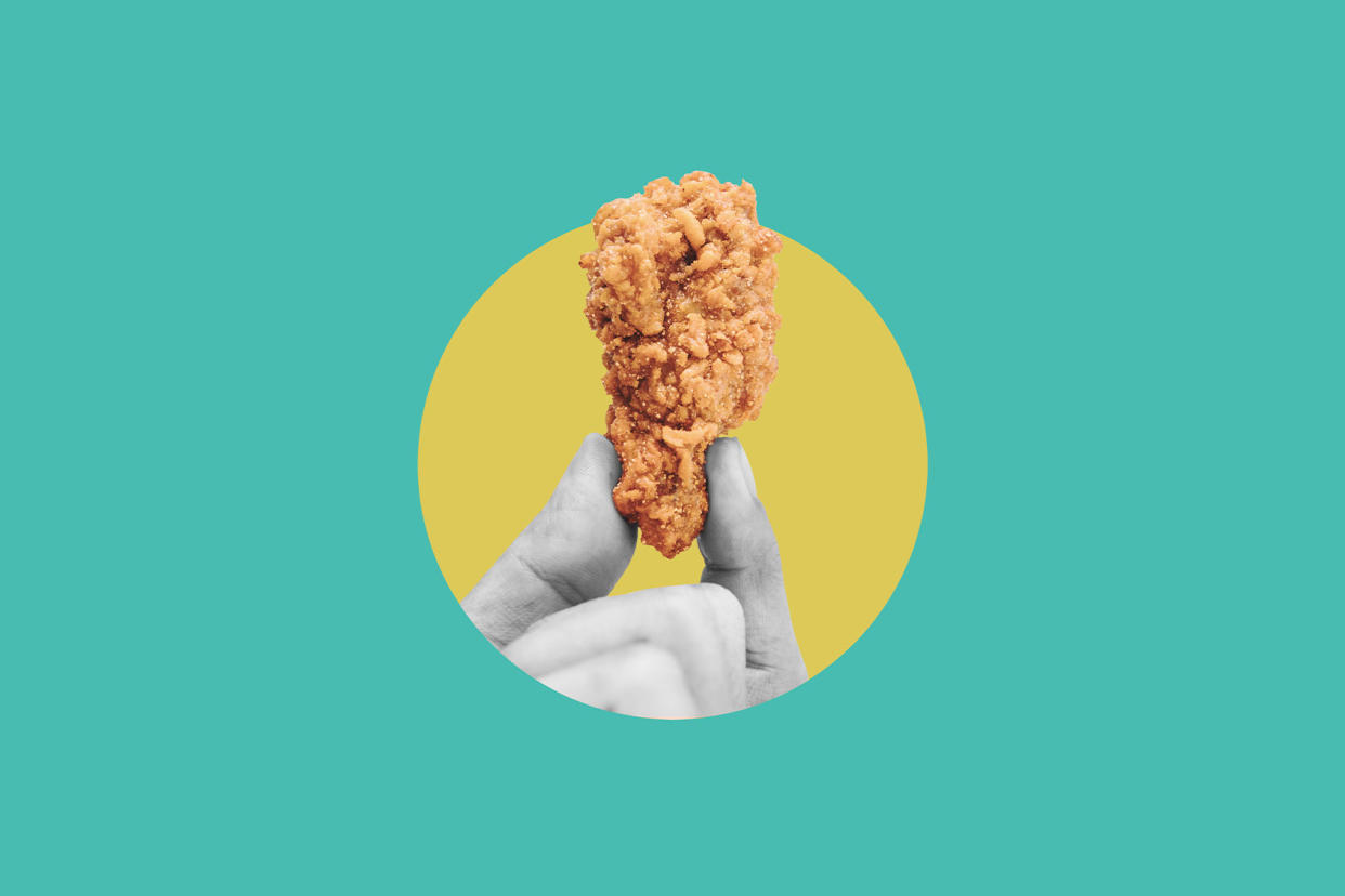 Hand holding fried chicken drumstick Getty Images/Sasin Paraksa