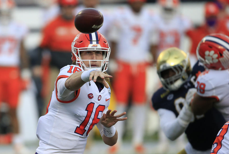 FILE - In this Saturday, Dec. 19, 2020, file photo, Clemson quarterback Trevor Lawrence (16) throws to an open receiver during the first half of the Atlantic Coast Conference championship NCAA college football game against Notre Dame in Charlotte, N.C. Lawrence has been named a finalist for the Heisman Trophy. The Heisman will be awarded Jan. 5 during a virtual ceremony as the pandemic forced the cancellation of the usual trip to New York that for the presentation that usually comes with being a finalist. (AP Photo/Brian Blanco, File)