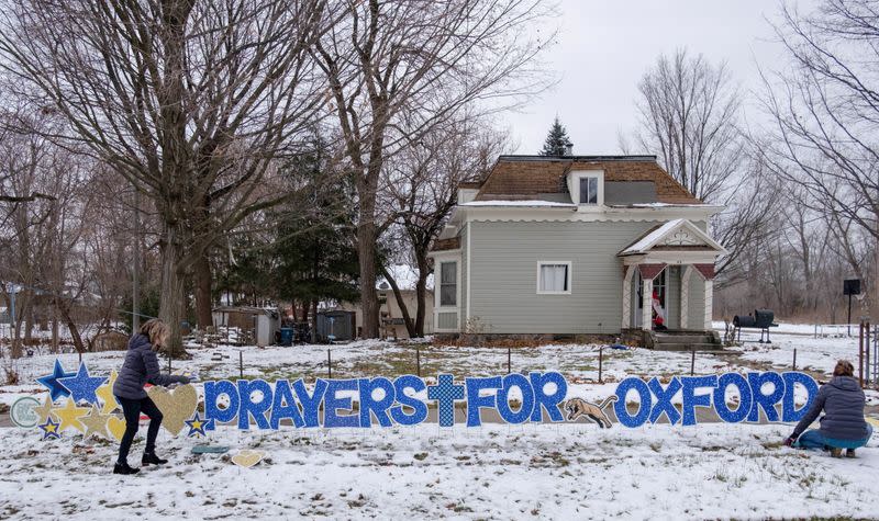 A sign reading "Pray for Oxford" is seen, a day after a shooting that left four dead and eight injured, in Oxford