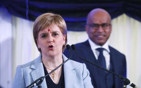 Scotland's First Minister Nicola Sturgeon speaks while Liberty executive chairman, Sanjeev Gupta watches at the recommissioning of the works by Liberty Steel Group at the Dalzell steel plant in Motherwell, Britain September 28 2016. REUTERS/Russell Cheyne