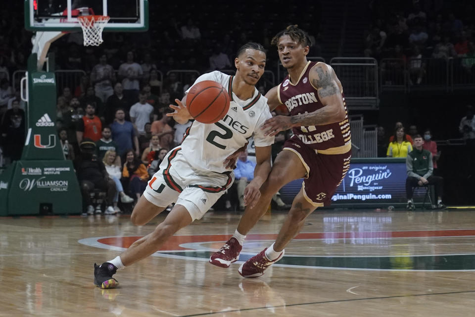 Boston College guard Makai Ashton-Langford (11) defends Miami guard Isaiah Wong (2) during the first half of an NCAA college basketball game, Wednesday, Jan. 11, 2023, in Coral Gables, Fla. (AP Photo/Marta Lavandier)