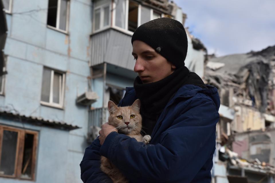 A man holding a cat rescued from the building in Zaporizhzhia which was hit by a rocket (Copyright 2023 The Associated Press. All rights reserved.)