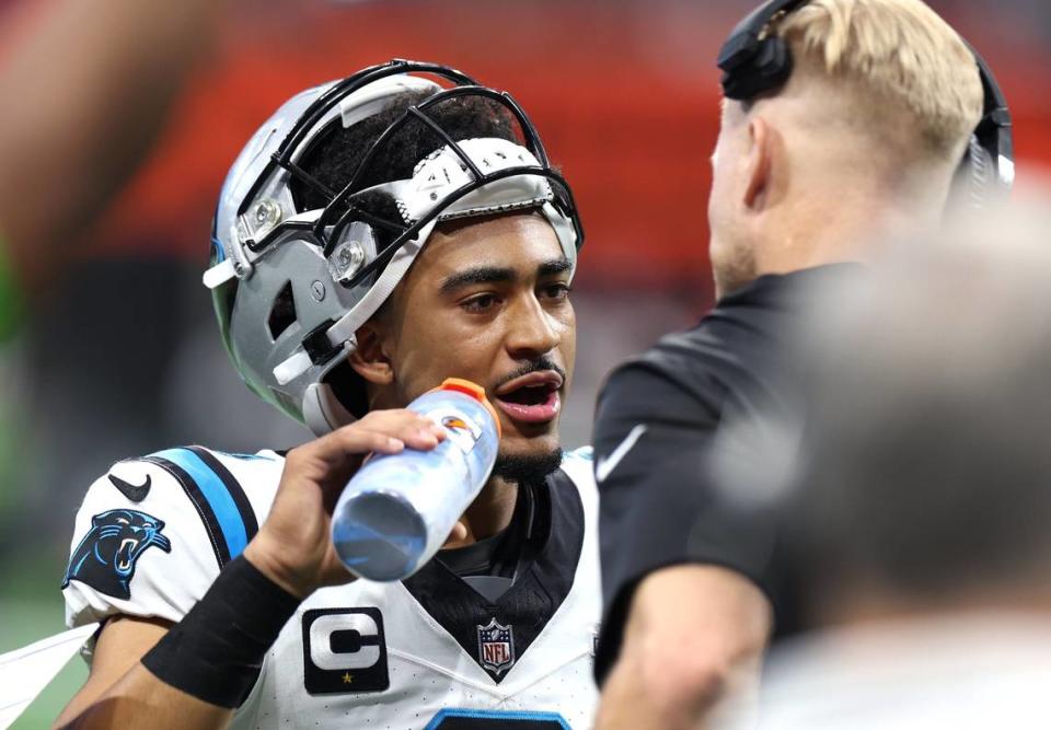 Carolina Panthers quarterback Bryce Young, left, talks with quarterbacks coach Josh McCown, right, during first half action against the Atlanta Falcons at Mercedes-Benz Stadium in Atlanta, GA on Sunday, September 10, 2023. The Falcons defeated the Panthers 24-10.