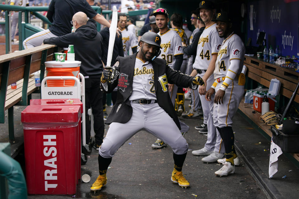 Pittsburgh Pirates' Miguel Andujar celebrates in the dugout after hitting a two-run home run in the sixth inning of the first baseball game of a doubleheader against the Washington Nationals, Saturday, April 29, 2023, in Washington. (AP Photo/Patrick Semansky)