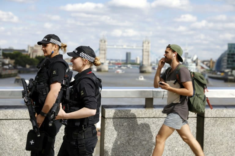 Armed police officers patrol on London Bridge in London on June 7, 2017, one of the scenes of the June 3 terror attack