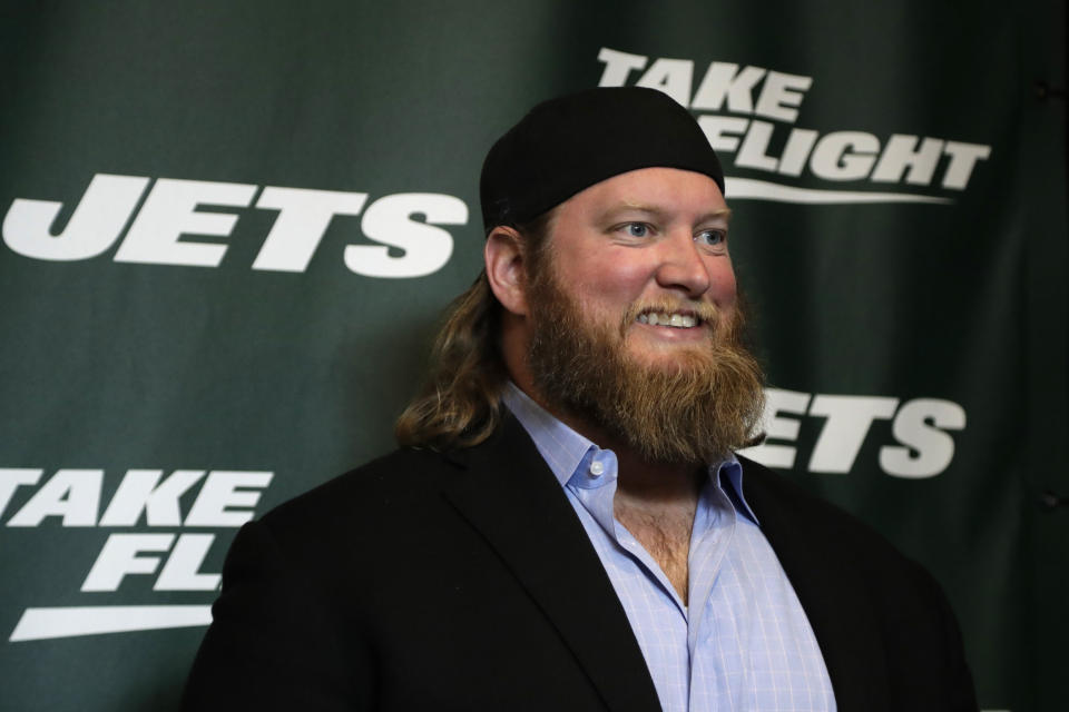 FILE - Former New York Jets center Nick Mangold poses for photographers on the green carpet ahead of an event unveiling the team's new NFL football uniforms, Thursday, April 4, 2019, in New York. The Jets will induct former cornerback Darrelle Revis, center Nick Mangold and left tackle D'Brickashaw Ferguson into the team's Ring of Honor during separate halftime ceremonies this season. The team announced Thursday, June 2, 2022, that Mangold will be the first honored with a ceremony during the Jets' game against Cincinnati on Sept. 25. Ferguson's induction will be Oct. 30 against New England, and Revis' will be Nov. 27 against Chicago.(AP Photo/Julio Cortez, File)