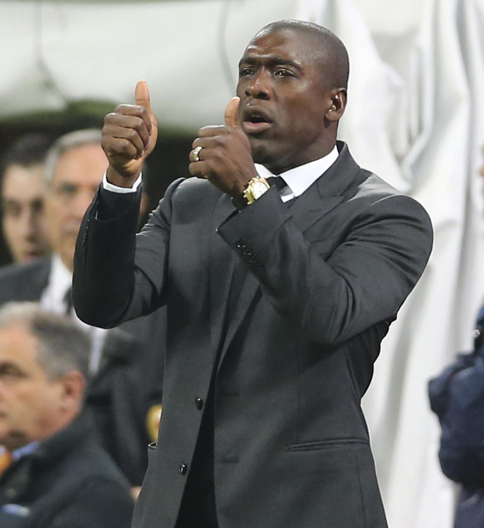 AC Milan coach Clarence Seedorf, of the Netherlands, gestures during the Serie A soccer match between AC Milan and Chievo Verona at the San Siro stadium in Milan, Italy, Saturday, March 29, 2014. (AP Photo/Antonio Calanni)