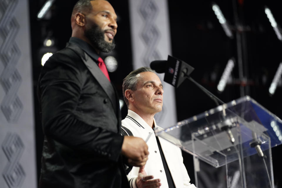 Matt Forte, left, and comedian Sean Sebastian Maniscalco announce Washington cornerback Kyler Gordon as the Chicago Bears pick during the second round of the NFL football draft Friday, April 29, 2022, in Las Vegas. (AP Photo/John Locher)